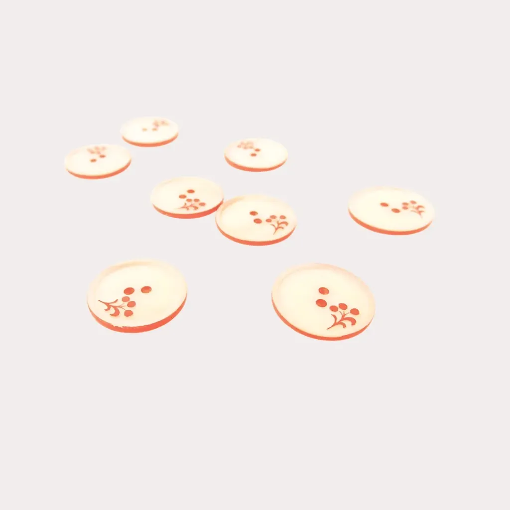 Boutons ronds à bord orange et petite fleur